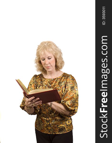 Attractive older woman holding a address book as she is checking addresses and isolated. Attractive older woman holding a address book as she is checking addresses and isolated