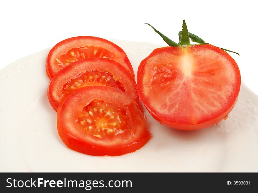 Tomatoes on plate isolated on a white background covered by drops of water