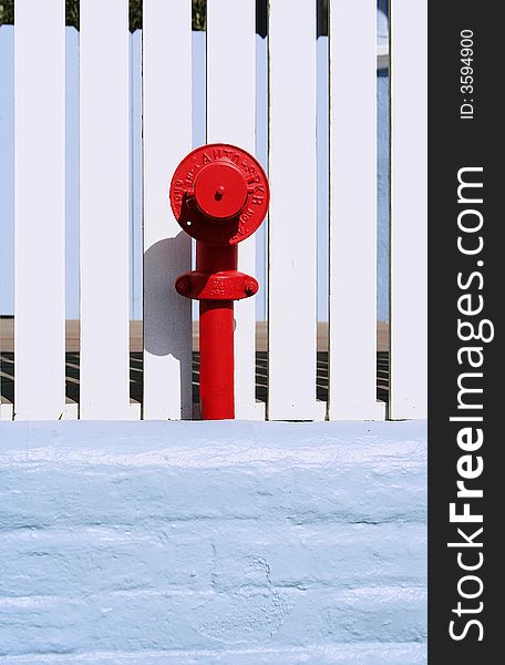 Red fire hydrants againts white fence. taken at venice beach board walk