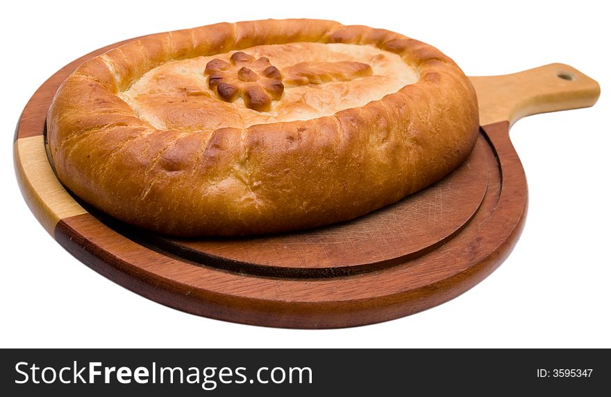 The celebratory pie lays on a board, isolated on a white background.