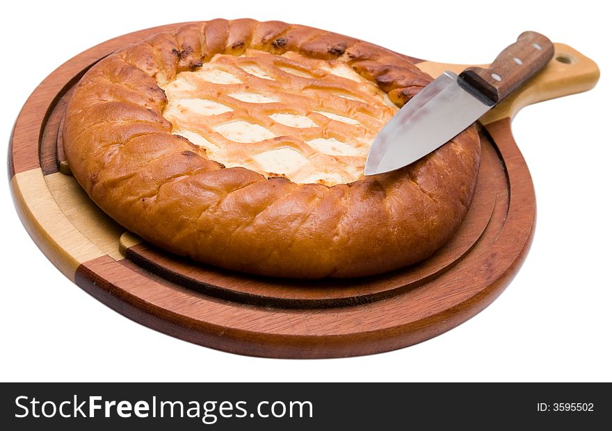 Celebratory pie on a chopping board with a knife.