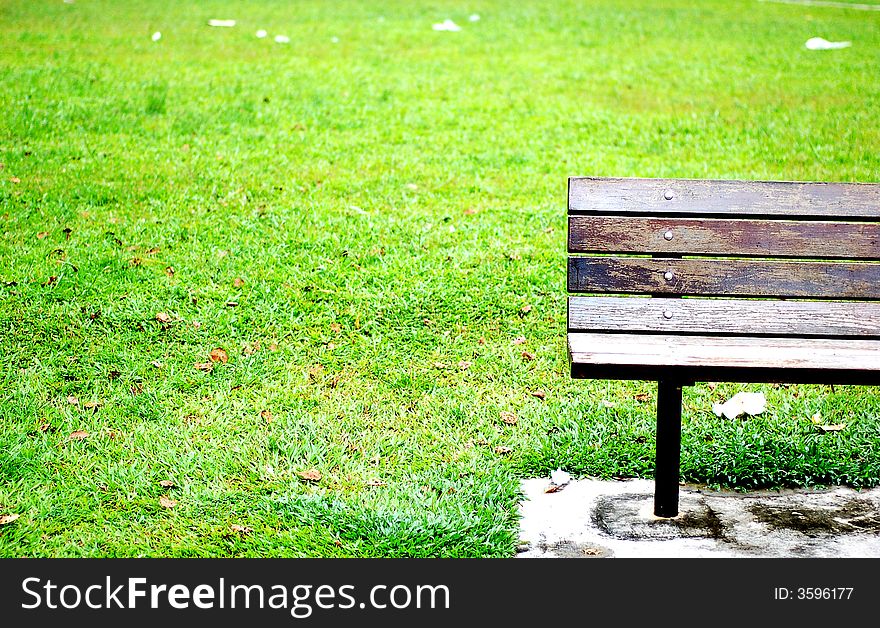 A vacant bench among green pastures. A vacant bench among green pastures