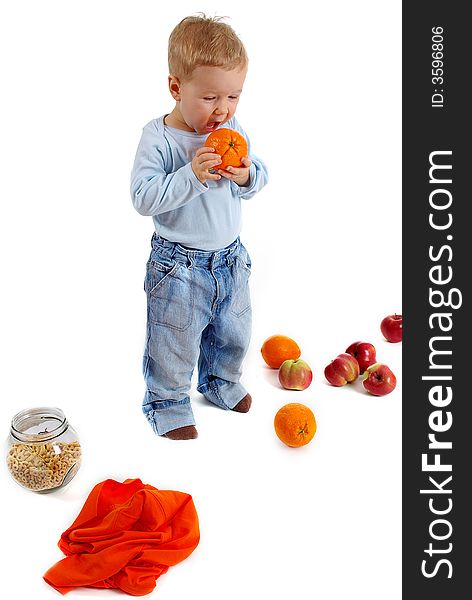 Happy boy with orange frutis over white background
