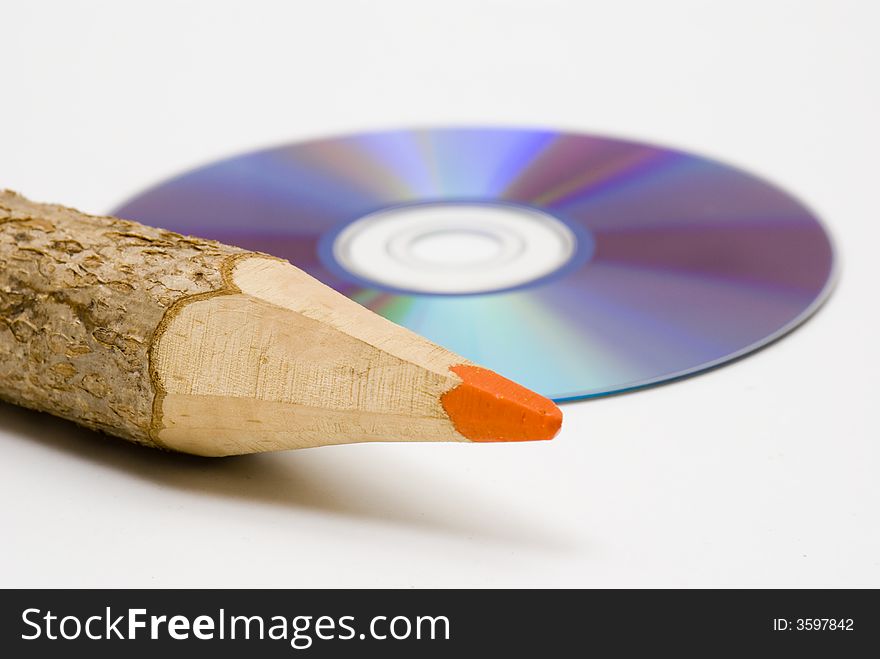 Colored pencil next to a CD. Colored pencil next to a CD