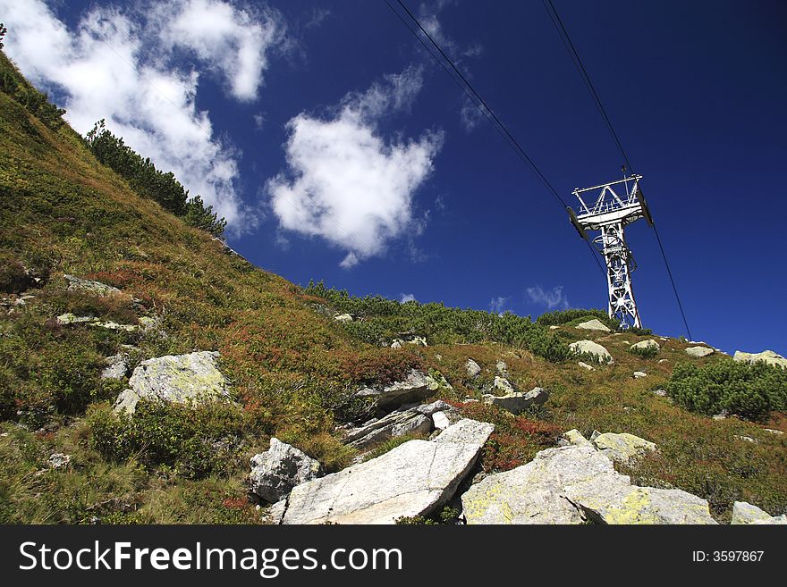 Alpine cablewya with the clouds and the rocks. Alpine cablewya with the clouds and the rocks