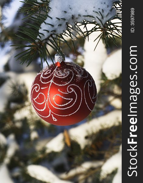 Christmas tree decoration handing on fir tree covered with snow. Christmas tree decoration handing on fir tree covered with snow