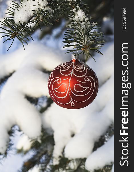 Christmas tree decoration handing on fir tree covered with snow. Christmas tree decoration handing on fir tree covered with snow