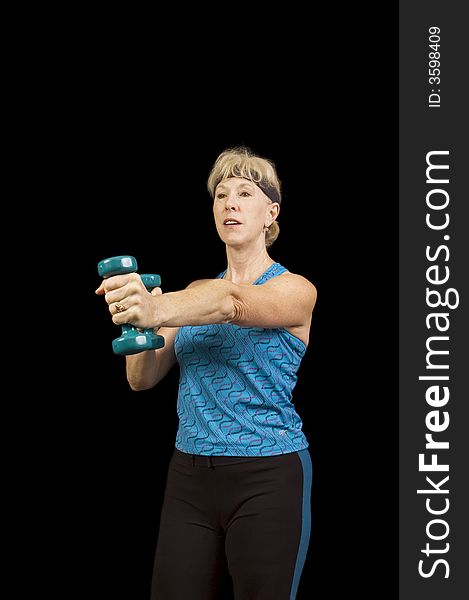 Middle-aged woman exercising with weights to music doing arobics and enjoying it. Middle-aged woman exercising with weights to music doing arobics and enjoying it
