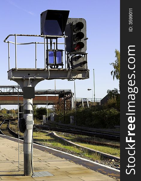 Railway signal gantry showing a red light. Railway signal gantry showing a red light