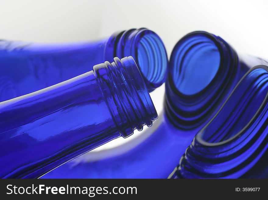 Mouth and neck of cobalt blue bottles with reflections