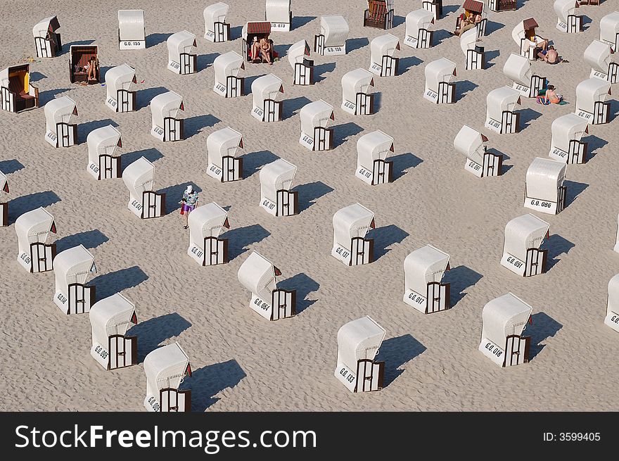 A hot summer day and a lot of beach chairs collected together at the Baltic Sea on RÃ¼gen nearby the Sellin Sea Bridge