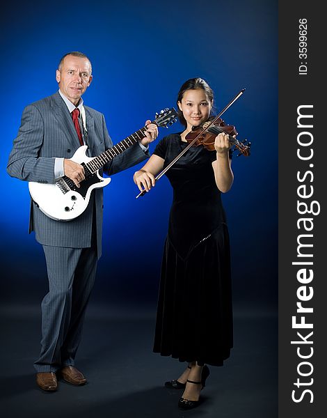 A photo of a duet - guitarist and violinist