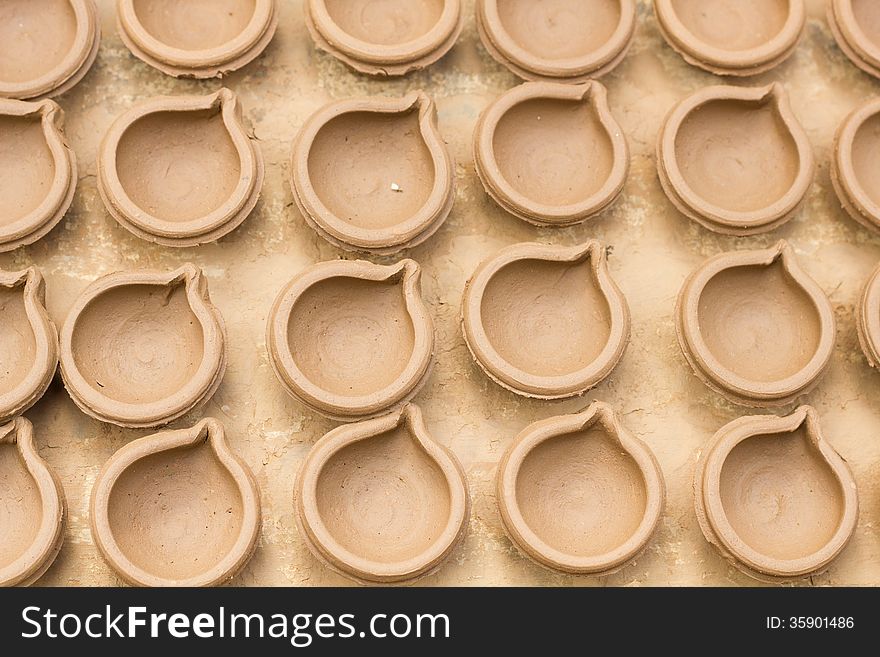 Indian diyas/cups made up of clay by pottery process. Indian diyas/cups made up of clay by pottery process
