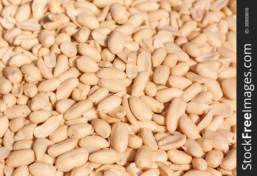 Peanuts Background. Close up of fried, peeled and salted peanuts.