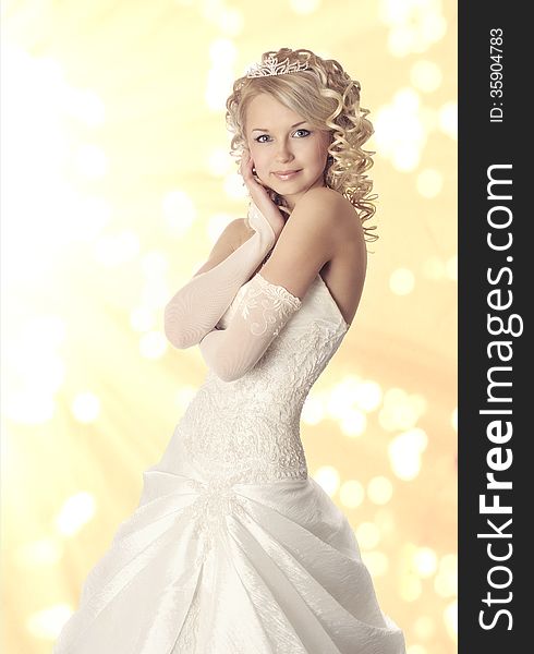 Portrait of a bride on yellow bokeh background.