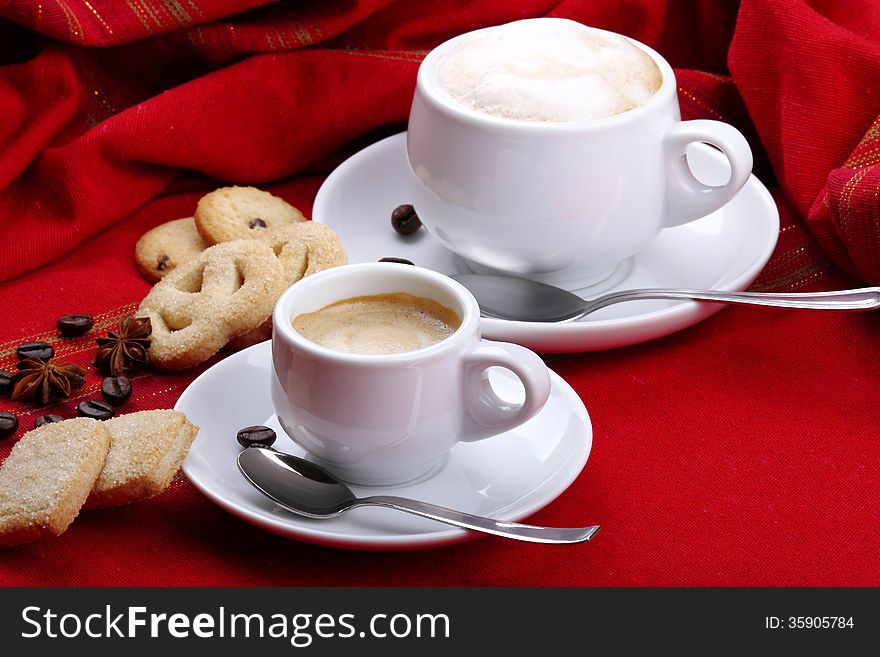 Milk and coffee with espresso on background of red cloth and pastries coffee grains. Milk and coffee with espresso on background of red cloth and pastries coffee grains