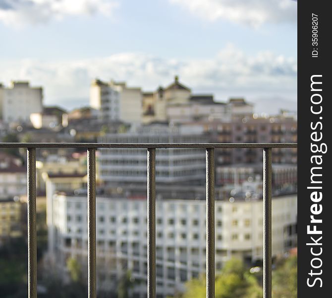 CITY IN THE BACKGROUND, VIEW THROUGH A RAILING IN THE SPOTLIGHT