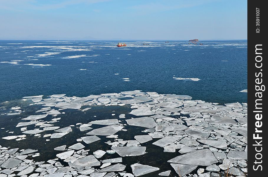 Floating of ice in Sea of Japan, ships in winter ocean, floating of ice