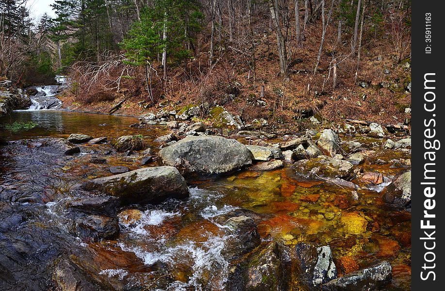 Forest river Voroshilovka, Primorye, Russia, early spring, taiga landscape