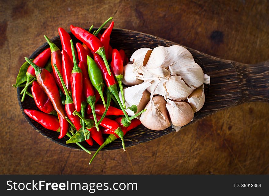 Red chili and garlic on wood ladle