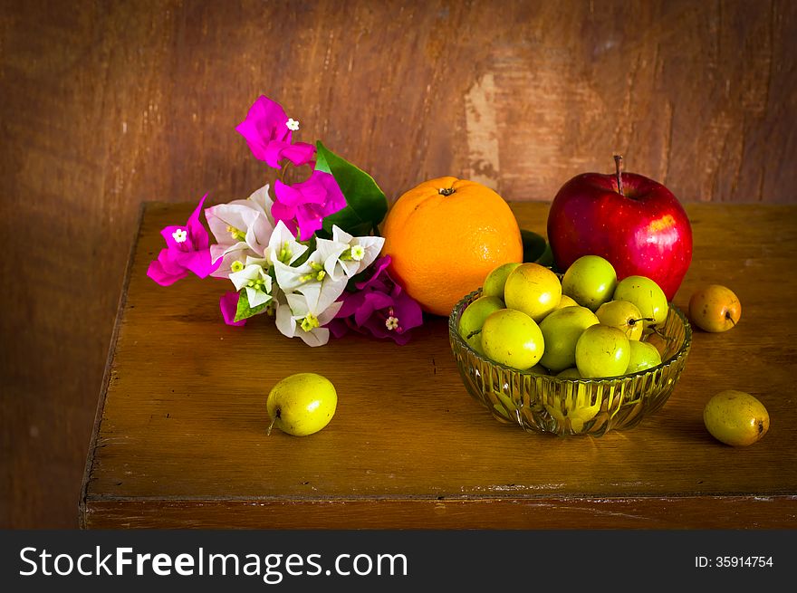 Fresh Bougainvillea flower and Many kind of fruit on old wood table ,still life. Fresh Bougainvillea flower and Many kind of fruit on old wood table ,still life