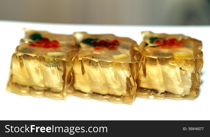 Bright tasty food fish in aspic on a light background. Bright tasty food fish in aspic on a light background