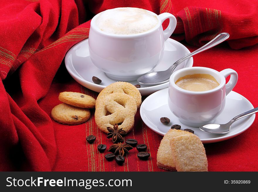 Milk and coffee with espresso on background of red cloth and pastries coffee grains. Milk and coffee with espresso on background of red cloth and pastries coffee grains