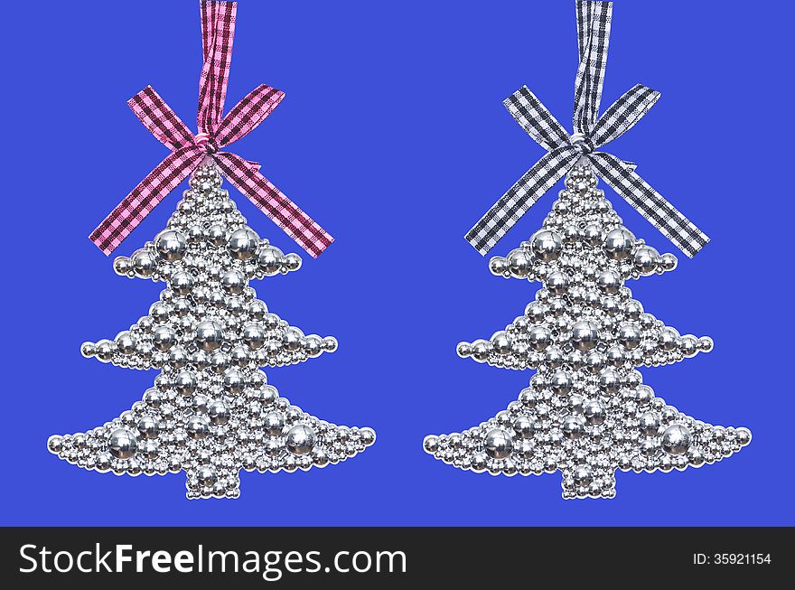Two silver Christmas tree - decoration isolated on blue background. Two silver Christmas tree - decoration isolated on blue background