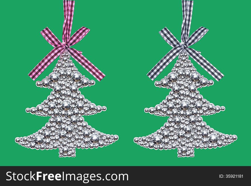 Two silver Christmas tree - decoration isolated on green background. Two silver Christmas tree - decoration isolated on green background