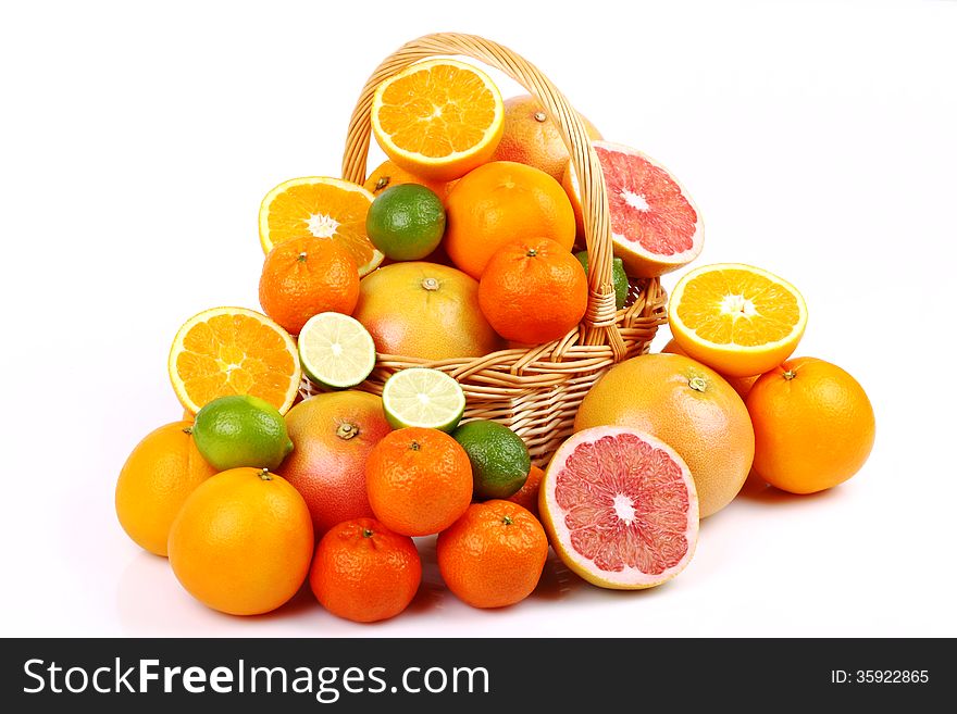 Wicker basket with various types of citrus fruits on white background. Wicker basket with various types of citrus fruits on white background