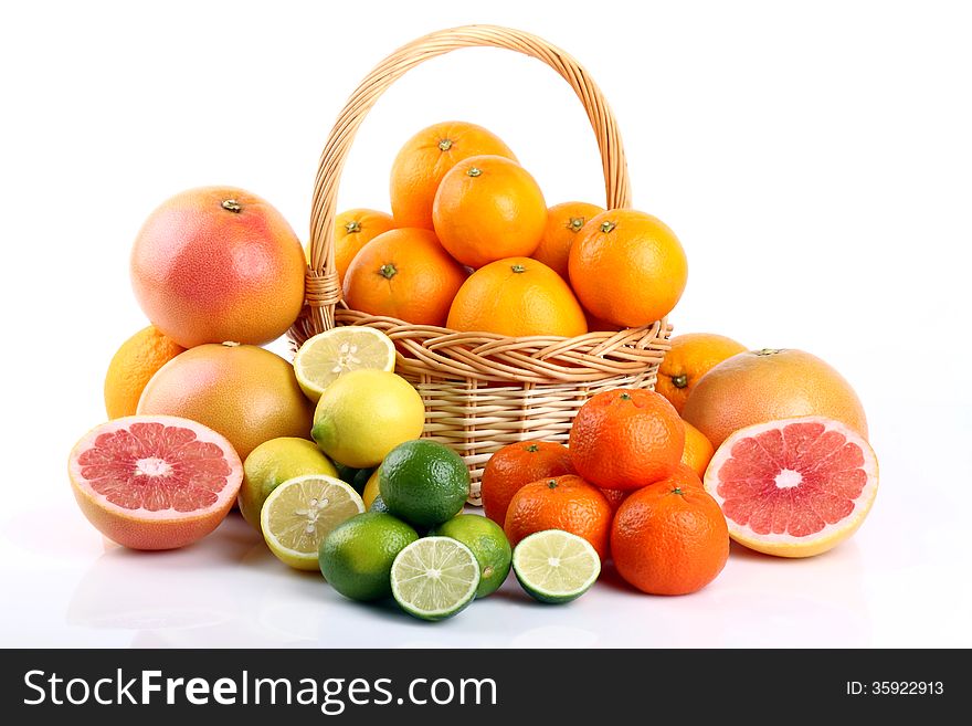 Wicker basket with various types of citrus fruits on white background. Wicker basket with various types of citrus fruits on white background