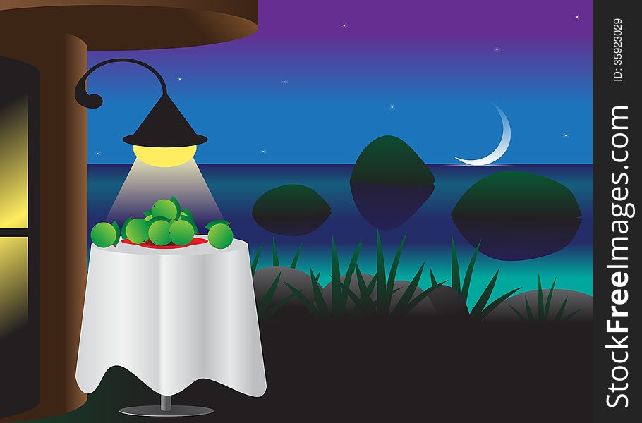 Landscape. Terrace at night , overlooking the water and a table with apples