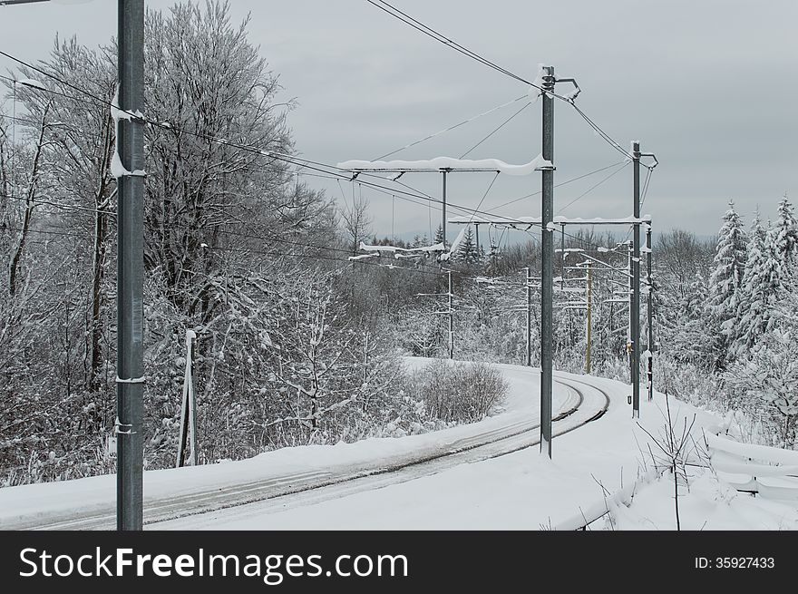 Electricity grid of train during a winter season covered by snow
