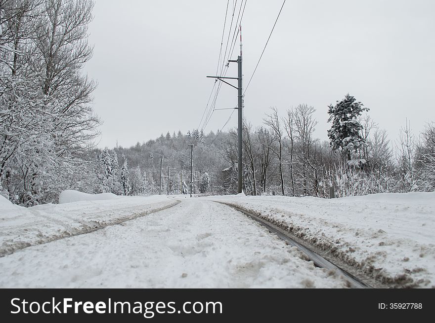 Electricity grid and track of train during a winter season covered by snow