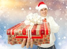 Young Man In Santa Claus Hat Holding A Gift Box Royalty Free Stock Photos Young Man In Santa Claus Hat Holding A Gift Box Royalty Free Stock Photos
