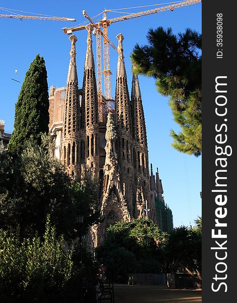 Facade of the Sagrada Familia near few construction cranes. Barcelona, Spain. Facade of the Sagrada Familia near few construction cranes. Barcelona, Spain