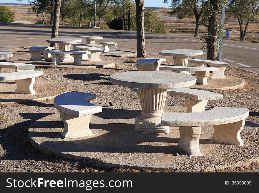 Picnic zone with stone benches and tables near highway. Picnic zone with stone benches and tables near highway