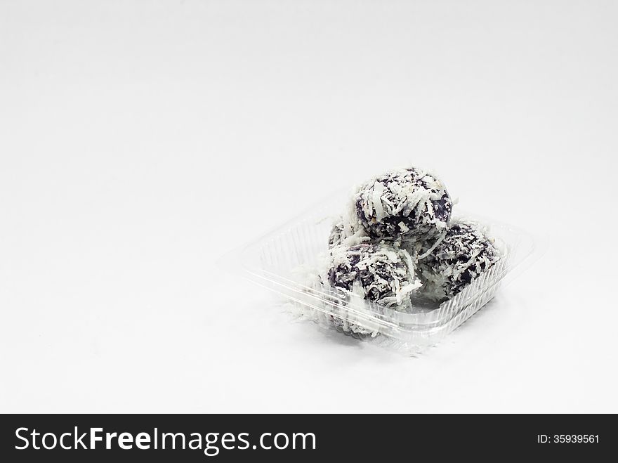 Thai dessert sweet boiled ball , roll over the grated coconut on White background