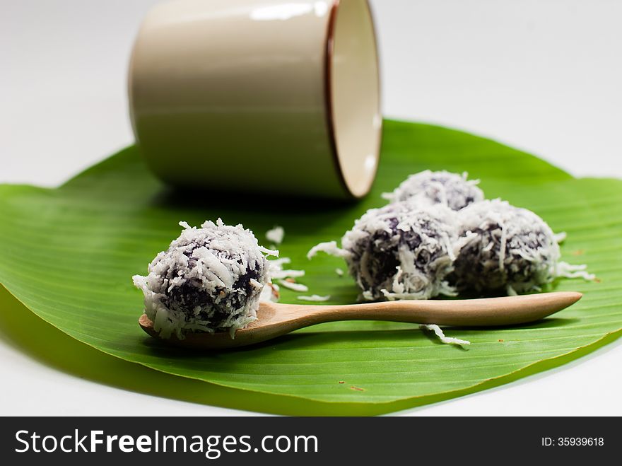 Thai dessert sweet boiled ball , roll over the grated coconut on the banana leaf