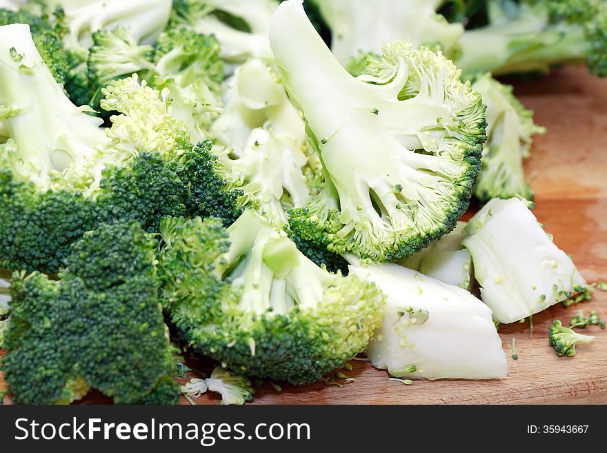 Cooking background. Broccoli closeup on wooden cutting board. Cooking background. Broccoli closeup on wooden cutting board