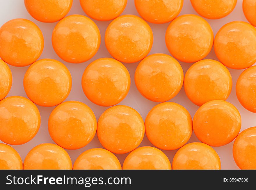 Background of stack orange pills. Background of stack orange pills