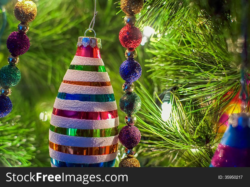 Christmas ornaments and decorations on a lit Christmas tree. Christmas ornaments and decorations on a lit Christmas tree