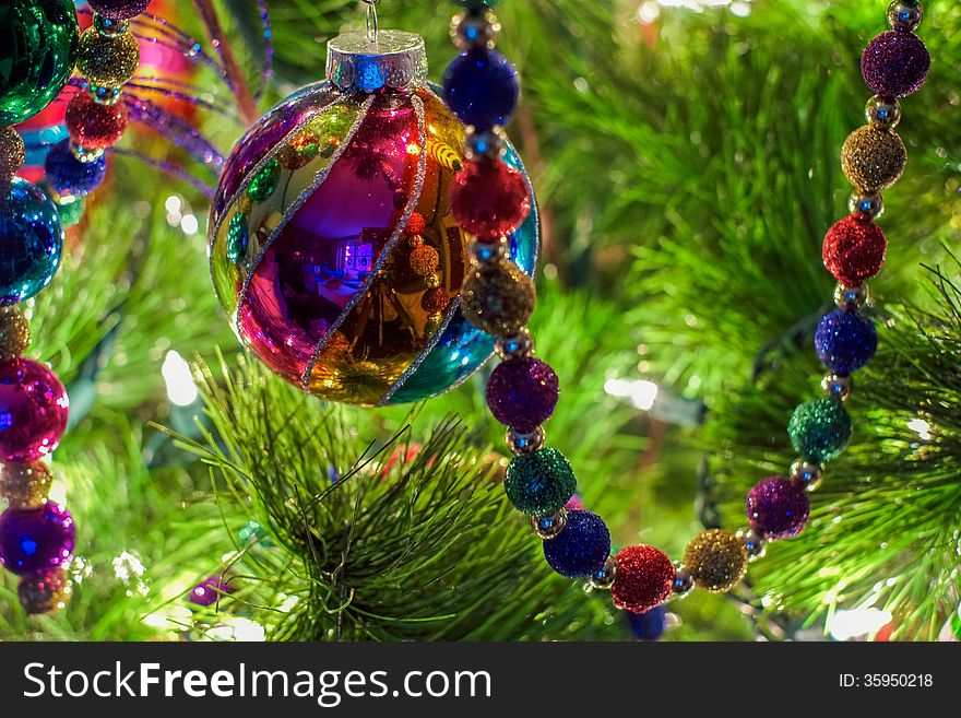 Christmas ornaments and decorations on a lit Christmas tree. Christmas ornaments and decorations on a lit Christmas tree