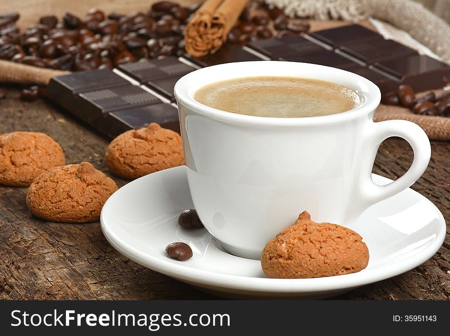 Coffee with almond cookies and chocolate