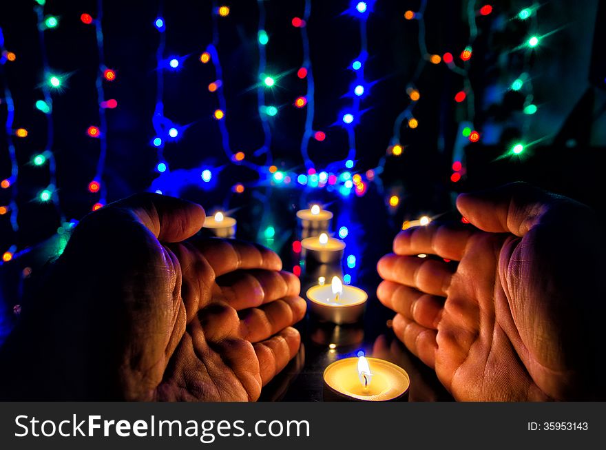 Hands and candles in front Christmas tree. Hands and candles in front Christmas tree