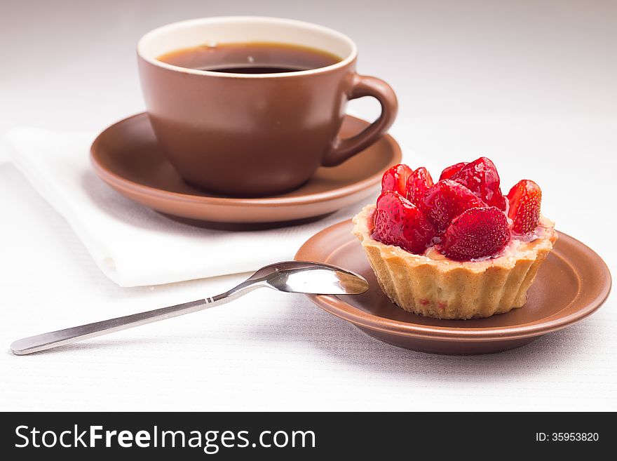 Strawberry dessert in Waffle Basket with Cup of Hot Tea. Strawberry dessert in Waffle Basket with Cup of Hot Tea