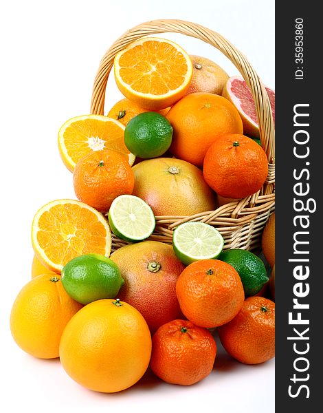 Wicker basket with various types of citrus fruits on white background. Wicker basket with various types of citrus fruits on white background