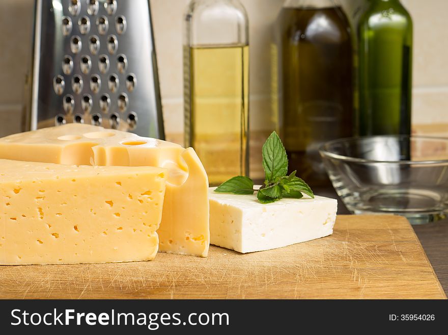 Various Type Of Cheese On Wooden Board