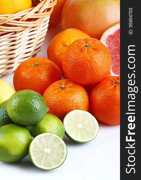 Wicker basket with various types of citrus fruits on white background. Wicker basket with various types of citrus fruits on white background