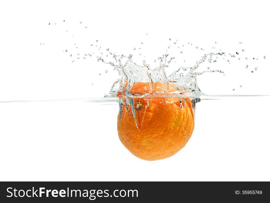 Orange falling into the water. Orange falling into the water